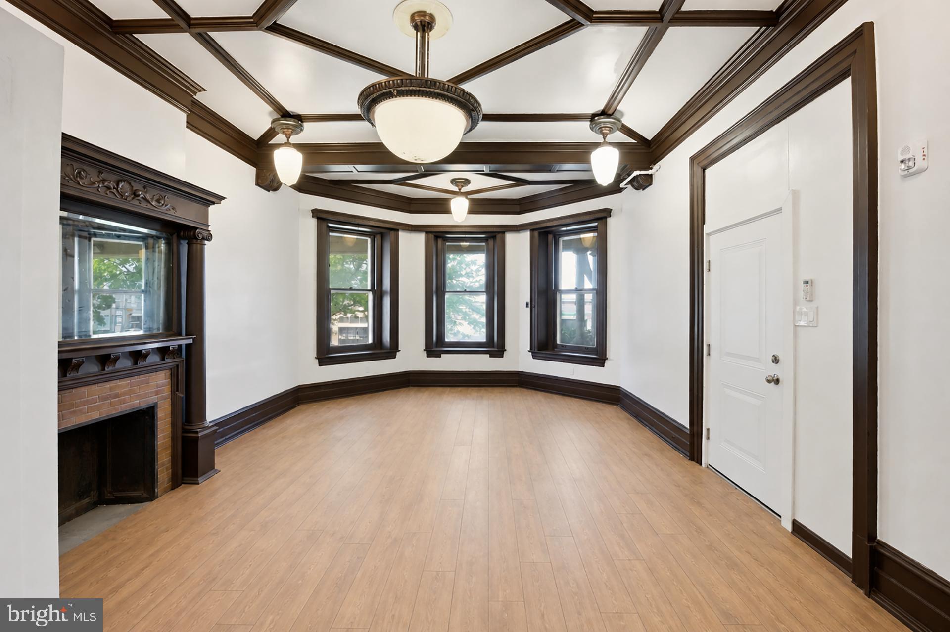 6012 Ridge Avenue, Unit 1 Philadelphia, PA 19128 - Photo 5 of 17 a view of an empty room with a window and wooden floor