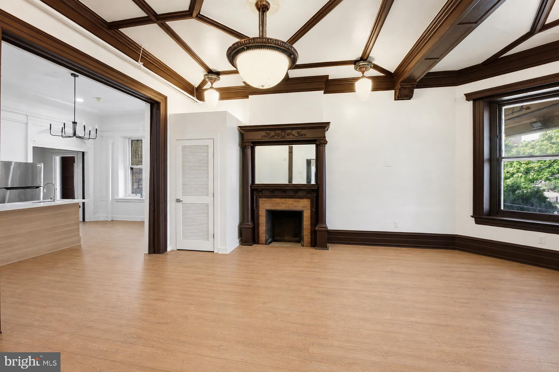 6012 Ridge Avenue, Unit 1 Philadelphia, PA 19128 - Photo 6 of 17 a view of an empty room with a fireplace and a window