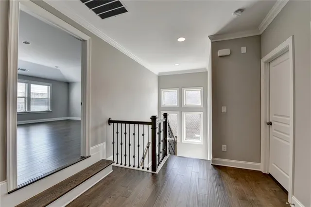 an empty room with closet and windows