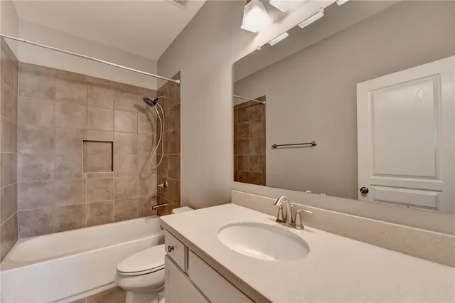 a front view of a house with a garden and yard