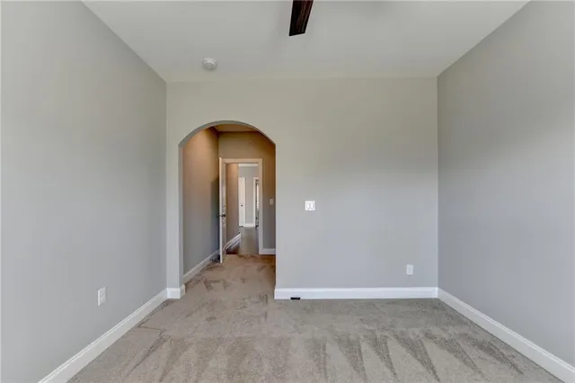 a view of a room with wooden floor and a floor to ceiling window