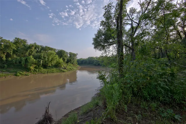 a kitchen with stainless steel appliances a table and chairs in it