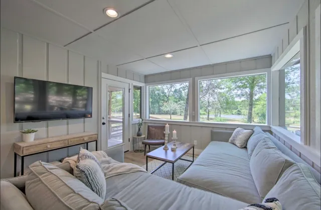 a bedroom with a bed and a large window with outer view