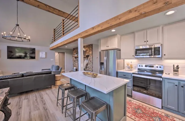 a kitchen with a table chairs refrigerator and cabinets
