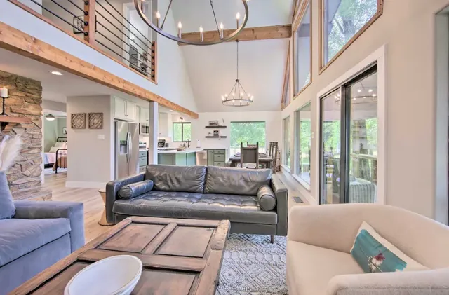 a living room with furniture and large windows