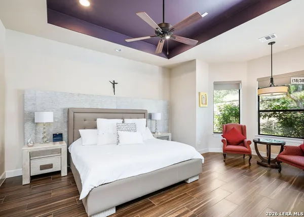 a bedroom with a bed chandelier and a window