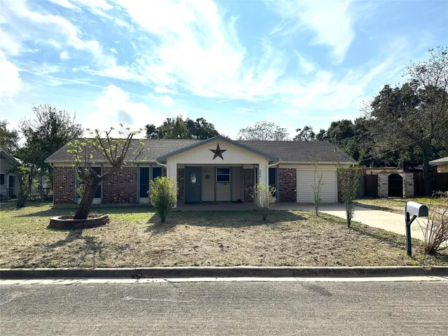a view of a house with a yard covered in snow