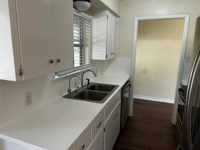 a kitchen with a sink and a refrigerator