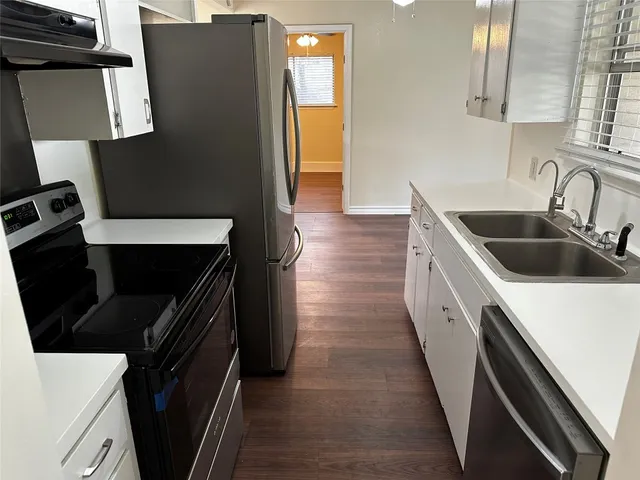 a kitchen with sink and cabinets