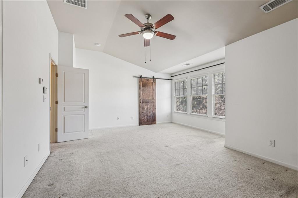 1465 Queens Lane Alpharetta, GA 30004 - Photo 11 of 24 an empty room with chandelier fan and windows
