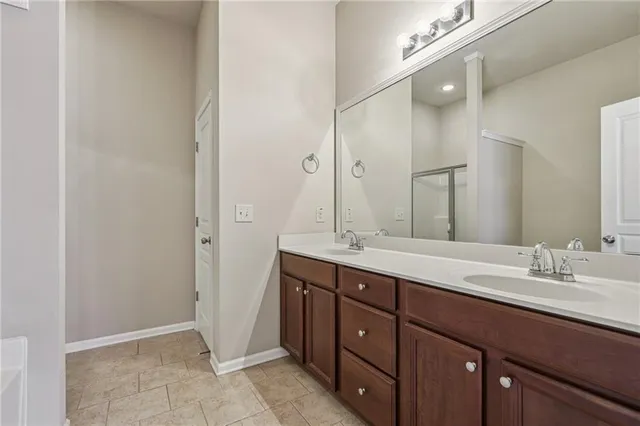 a bathroom with a double vanity sink and mirror