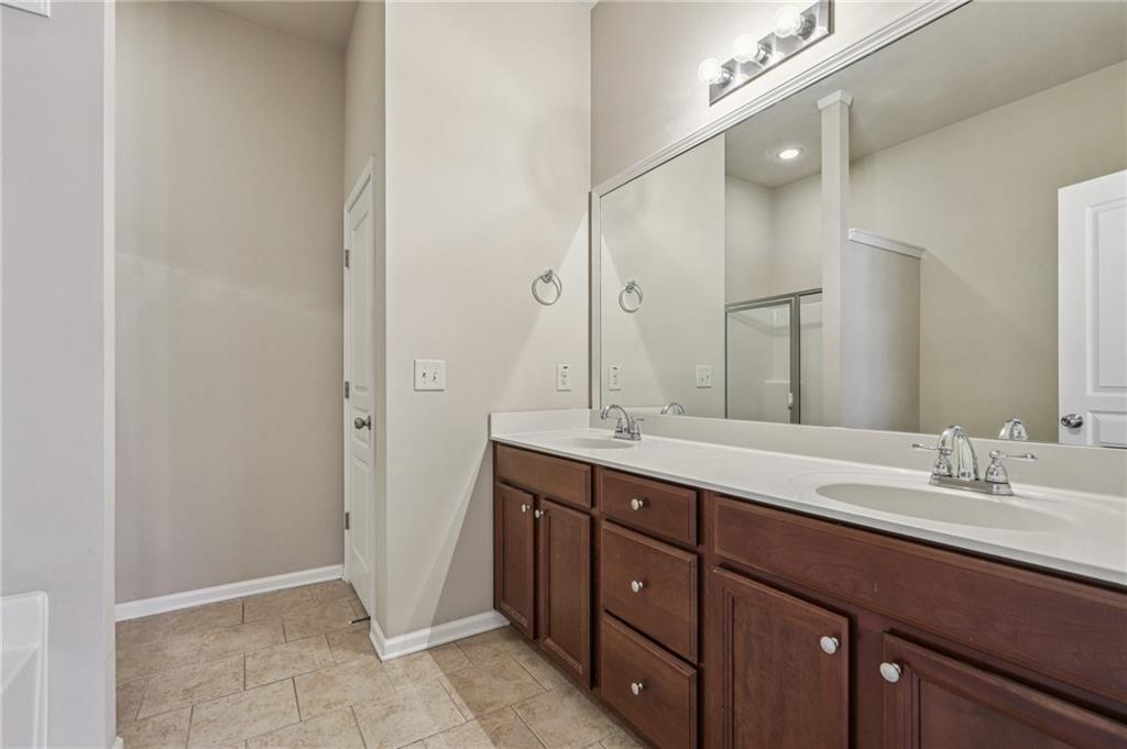 1465 Queens Lane Alpharetta, GA 30004 - Photo 12 of 24 a bathroom with a double vanity sink and mirror