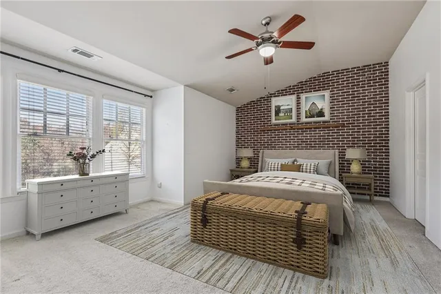 a bedroom with a bed and a desk chair in it