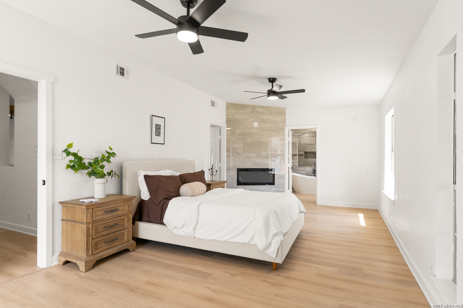 670 Quail Run Lytle, TX 78052 - Photo 13 of 31 a bedroom with a bed chandelier and a window