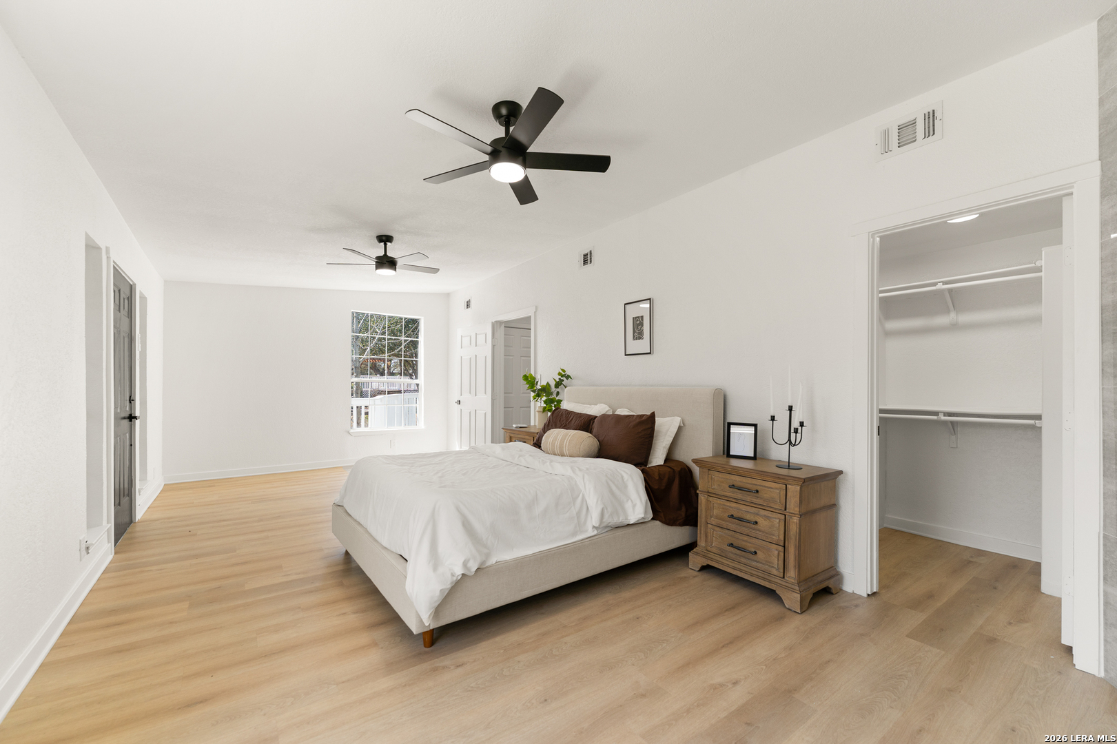 670 Quail Run Lytle, TX 78052 - Photo 18 of 31 a bedroom with a bed and a chandelier