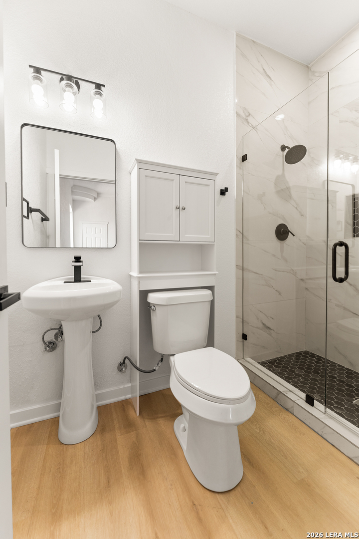 670 Quail Run Lytle, TX 78052 - Photo 20 of 31 a bathroom with a sink toilet and shower