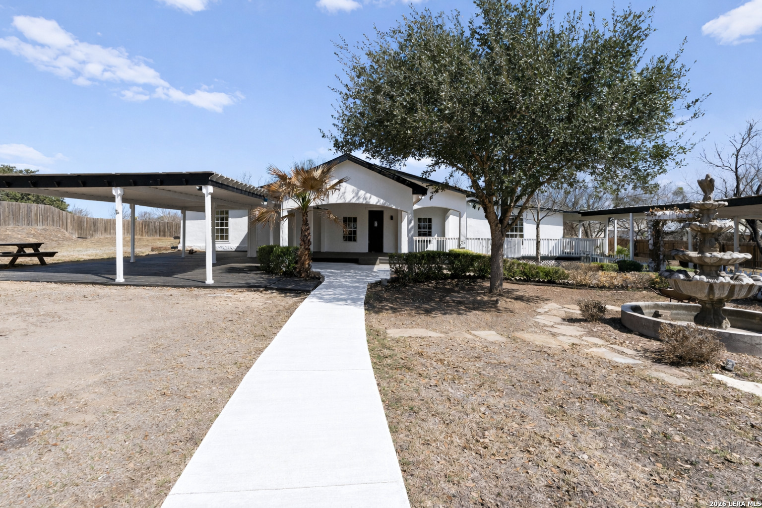670 Quail Run Lytle, TX 78052 - Photo 2 of 31 a front view of a house with a yard outdoor seating and covered with trees
