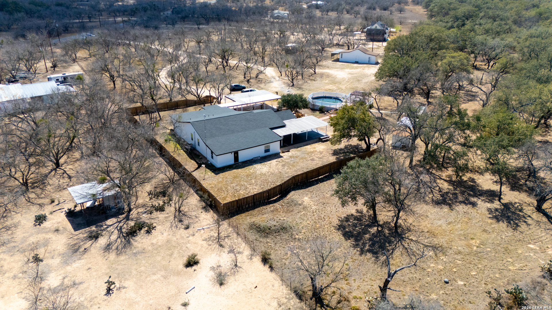 670 Quail Run Lytle, TX 78052 - Photo 30 of 31 a view of a yard with a tree