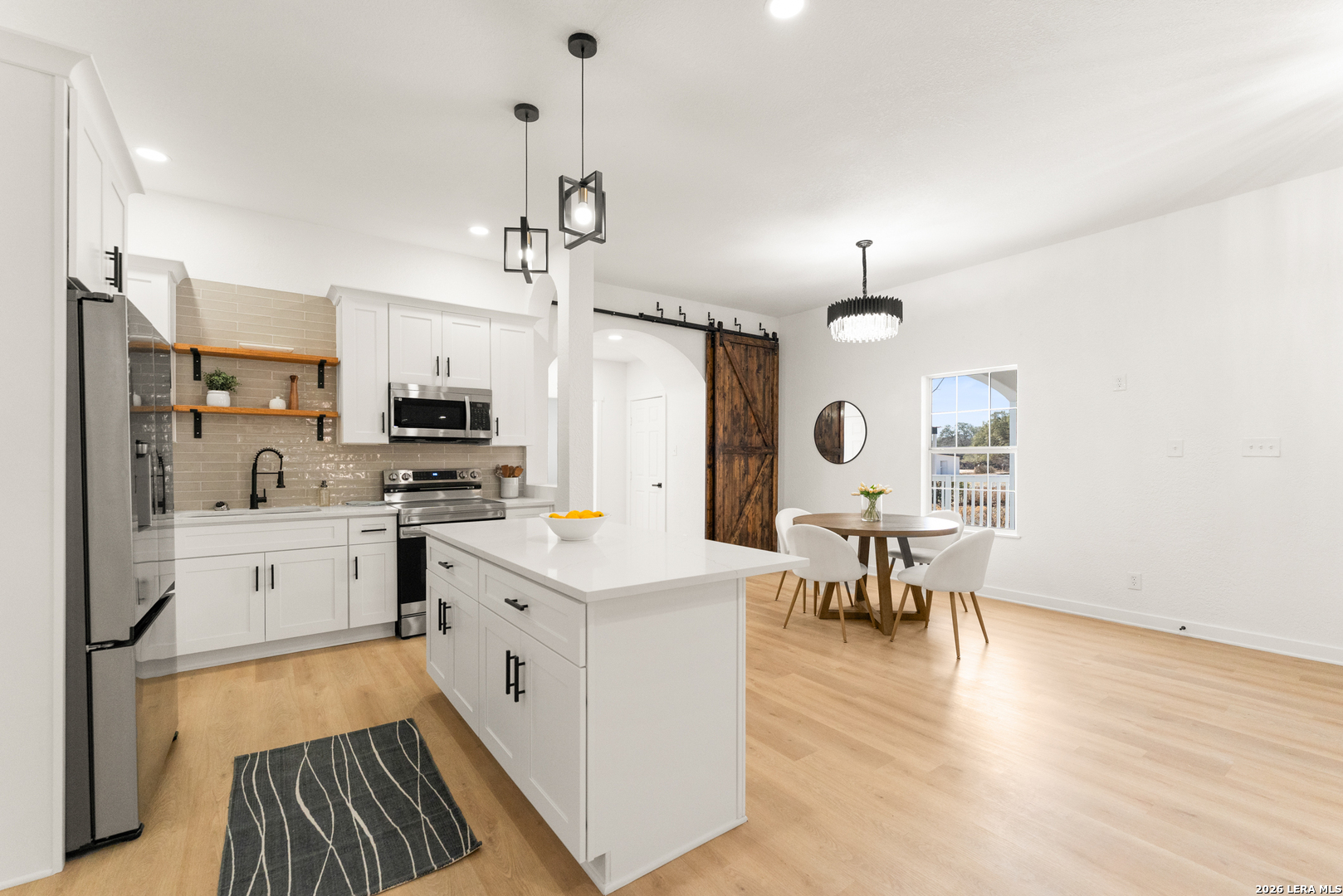 670 Quail Run Lytle, TX 78052 - Photo 8 of 31 a kitchen with white cabinets and white appliances