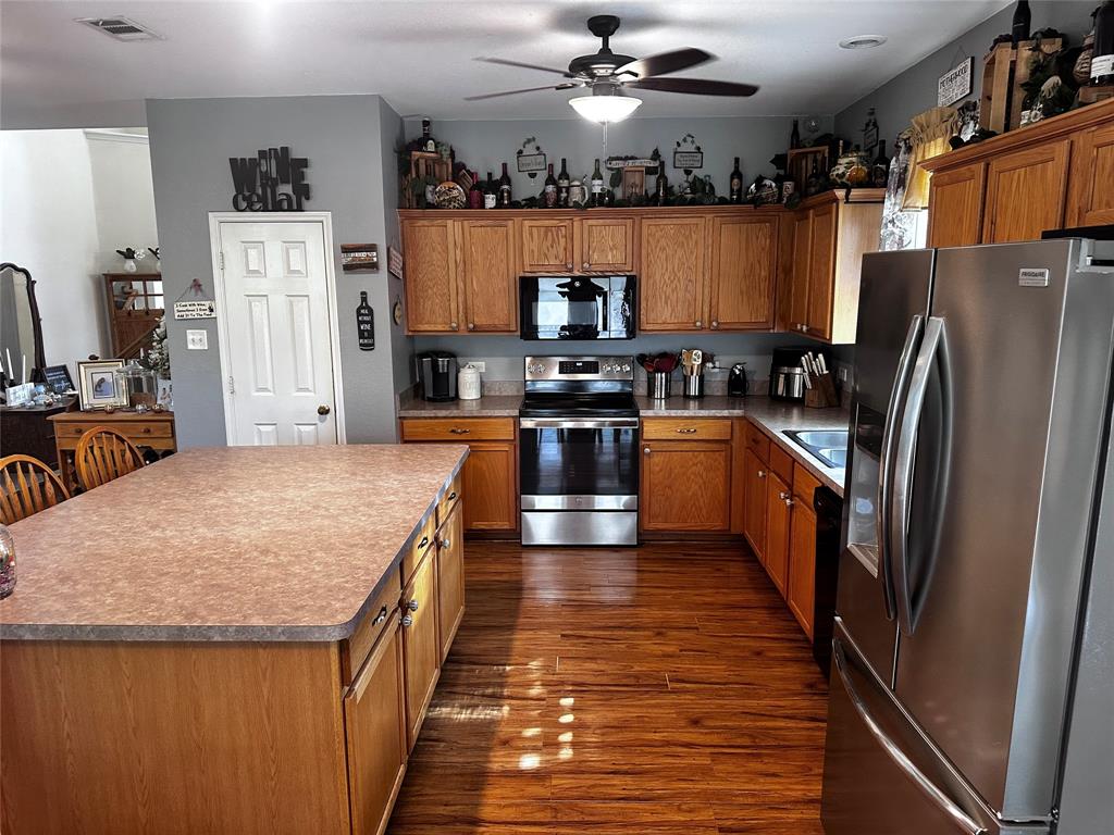 103 Denali Court Terrell, TX 75160 - Photo 11 of 39 a kitchen with stainless steel appliances granite countertop a refrigerator a stove top oven a sink and dishwasher