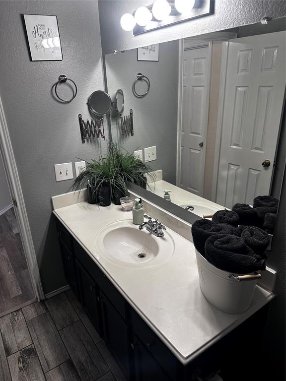 103 Denali Court Terrell, TX 75160 - Photo 34 of 39 a bathroom with a sink a mirror and a shower