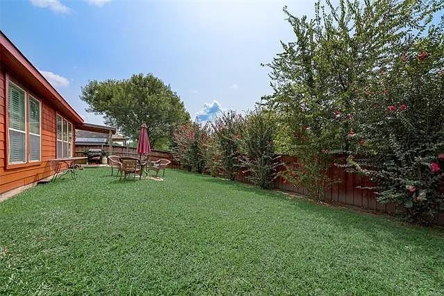 103 Denali Court Terrell, TX 75160 - Photo 38 of 39 a view of a backyard with table and chairs and potted plants and large trees