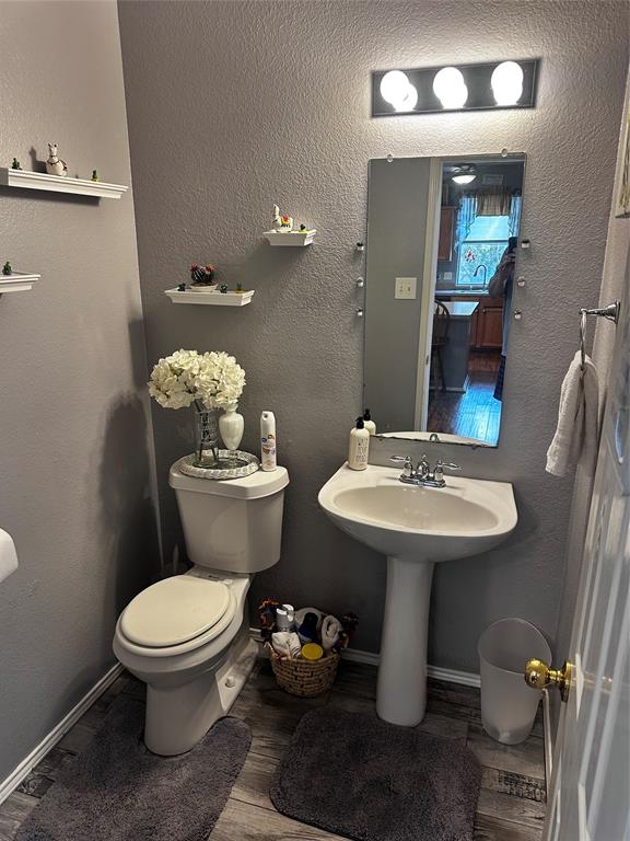 103 Denali Court Terrell, TX 75160 - Photo 9 of 39 a bathroom with a sink mirror toilet and a mirror
