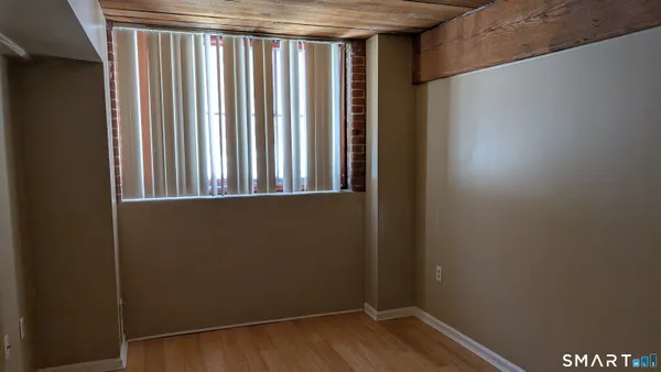a view of a small space with wooden floor