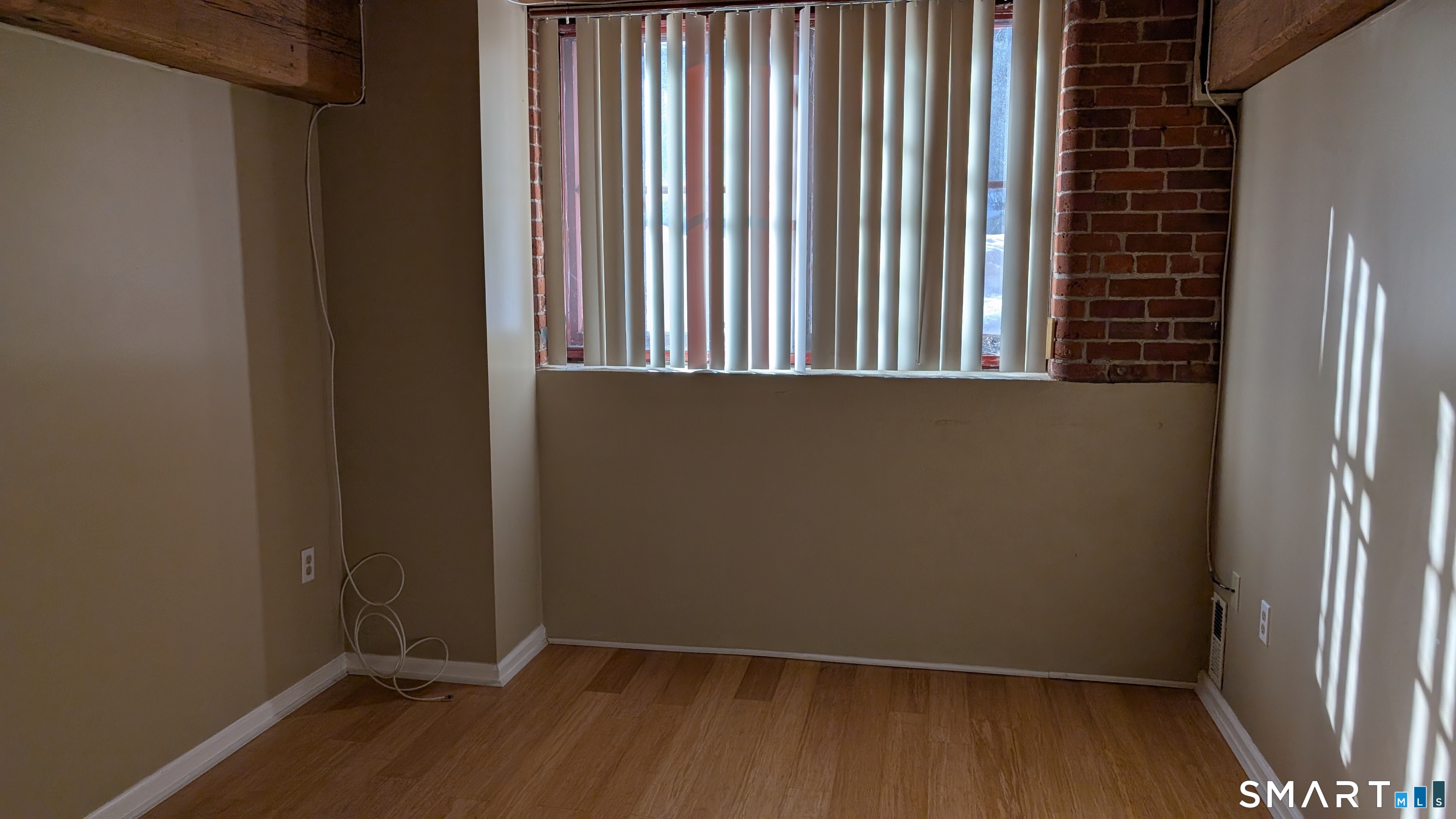 839 Main Street, Unit 98 Torrington, CT 06790 - Photo 16 of 49 a view of an empty room with wooden floor and a window