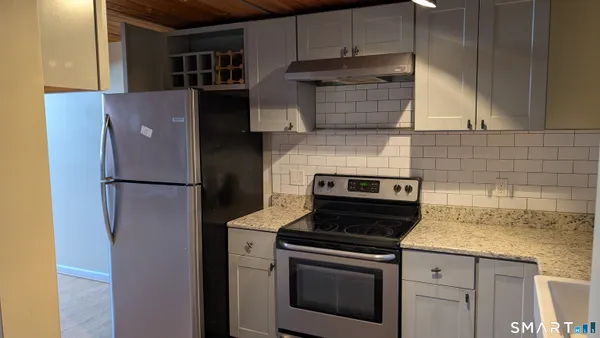 a kitchen with a stove microwave and refrigerator