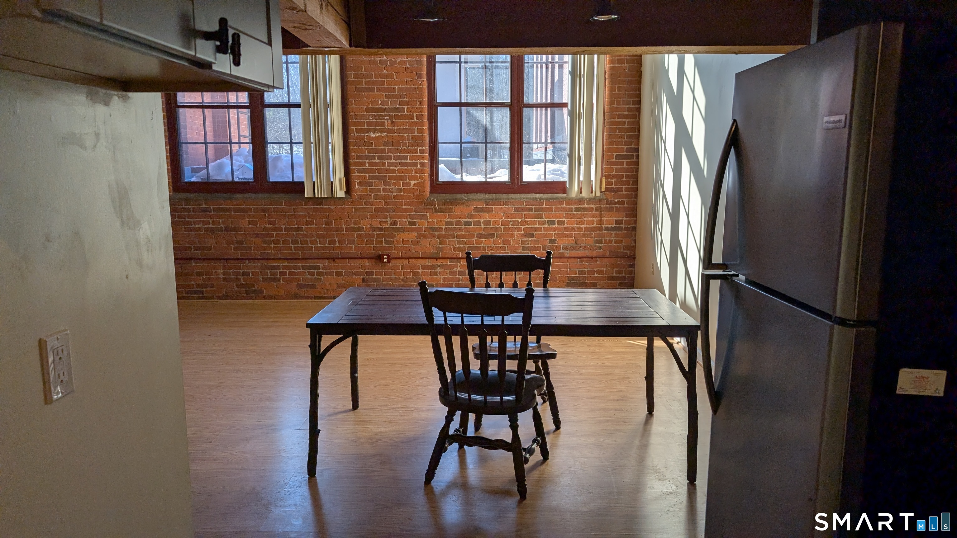 839 Main Street, Unit 98 Torrington, CT 06790 - Photo 24 of 49 a view of a dining room with furniture window and wooden floor