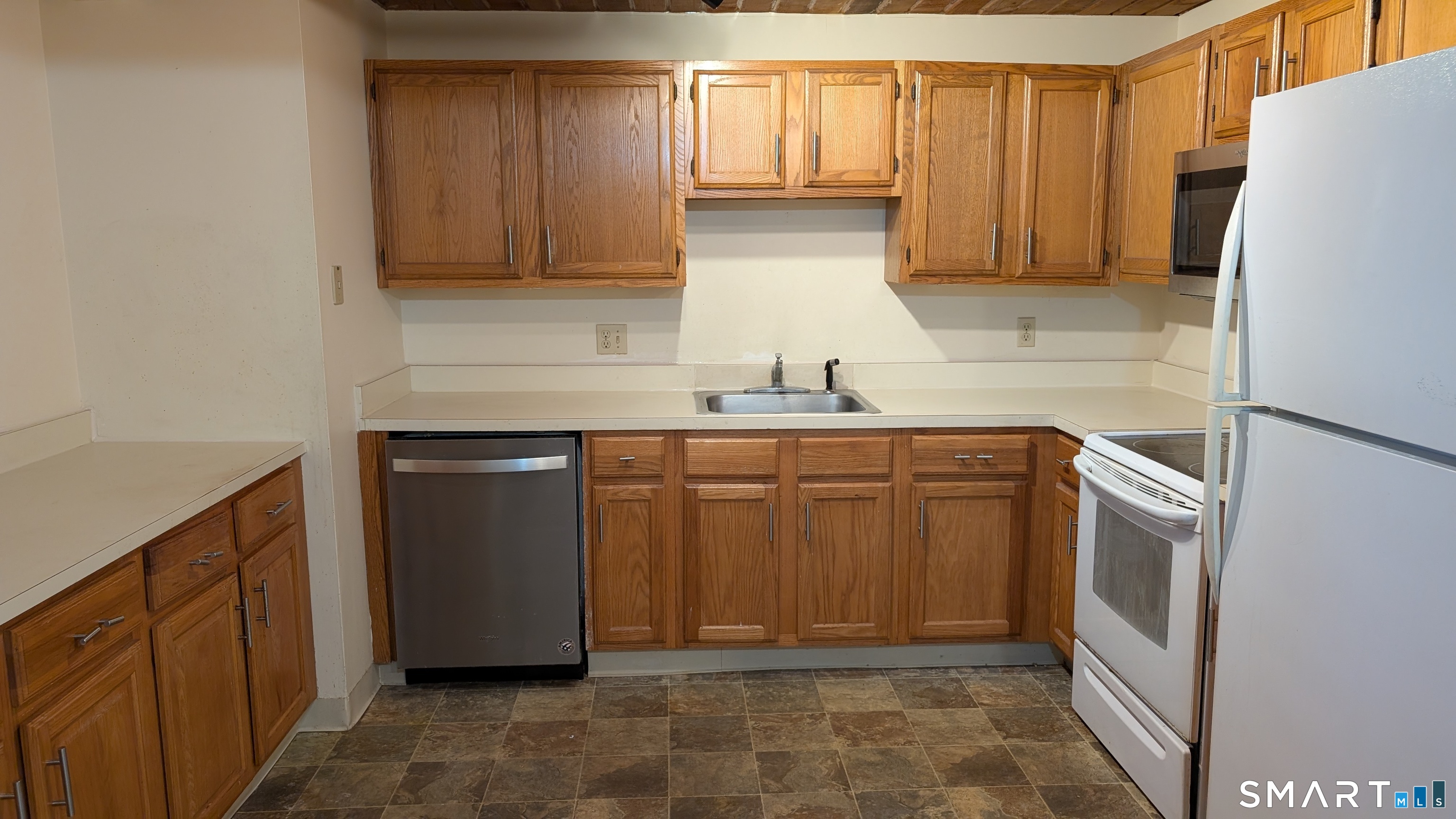 839 Main Street, Unit 98 Torrington, CT 06790 - Photo 10 of 49 a kitchen with a sink and a refrigerator