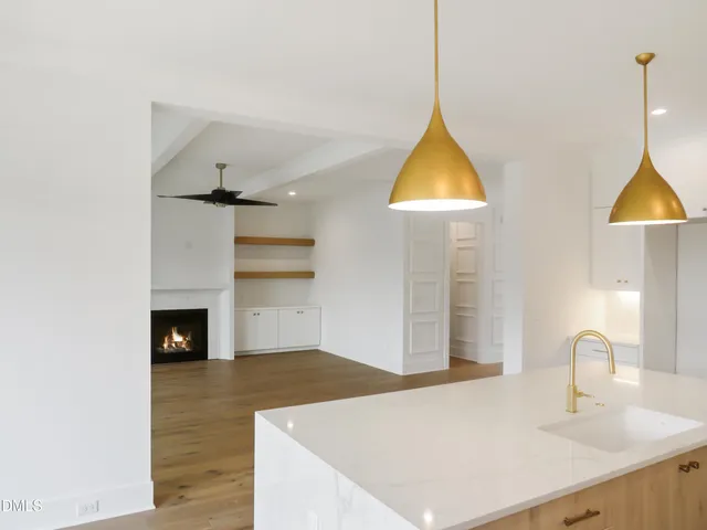 a spacious bathroom with double sink a toilet a shower and a mirror