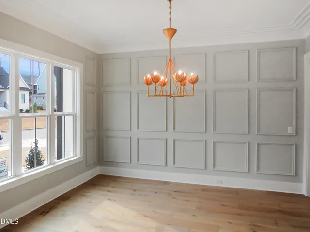 a kitchen with stainless steel appliances a refrigerator a sink dishwasher a stove and white cabinets with wooden floor