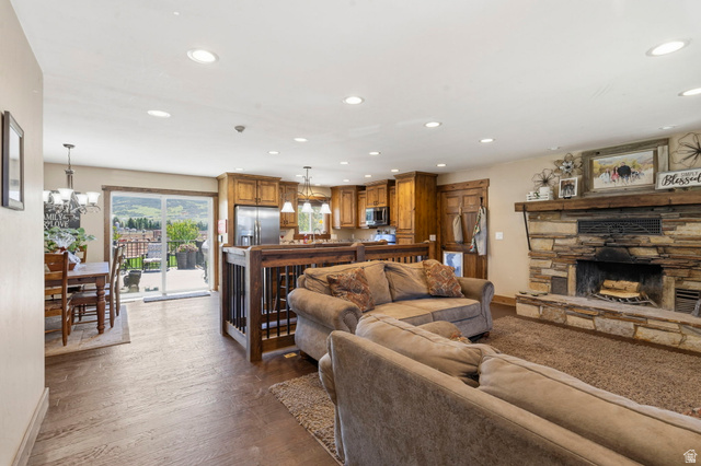 781 West 3000 South Heber City, UT 84032 - Photo 6 of 30 Living room featuring suspended lighting, dark wood-type flooring, and a fireplace