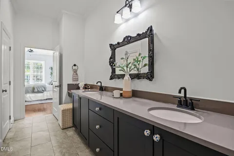 a bathroom with a granite countertop sink vanity and mirror