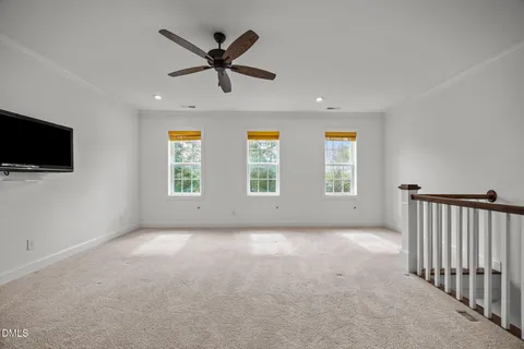 a view of a livingroom with a ceiling fan and window