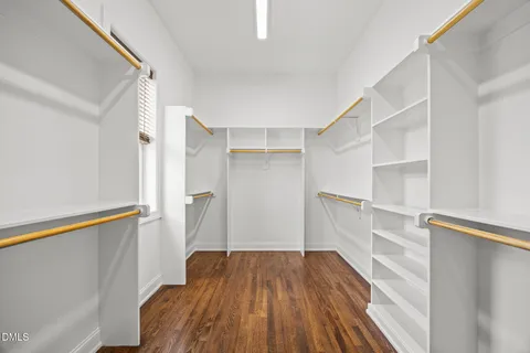 a view of walk in closet with empty racks