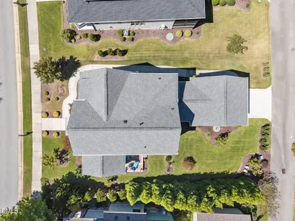 an aerial view of a residential houses with outdoor space