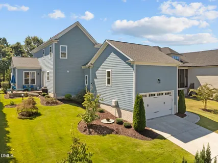 a view of house with yard outdoor seating area and barbeque oven