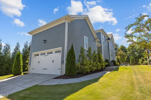 a view of backyard of house with green space