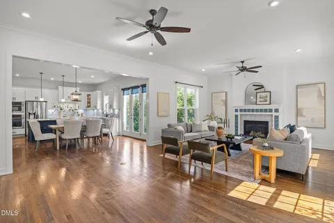 a living room with furniture a fireplace and a chandelier