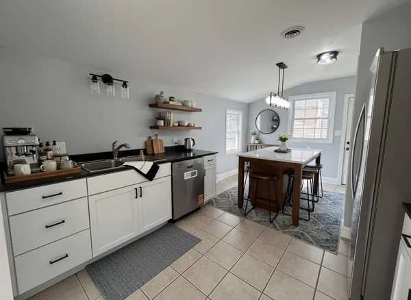 a kitchen with a sink cabinets and window