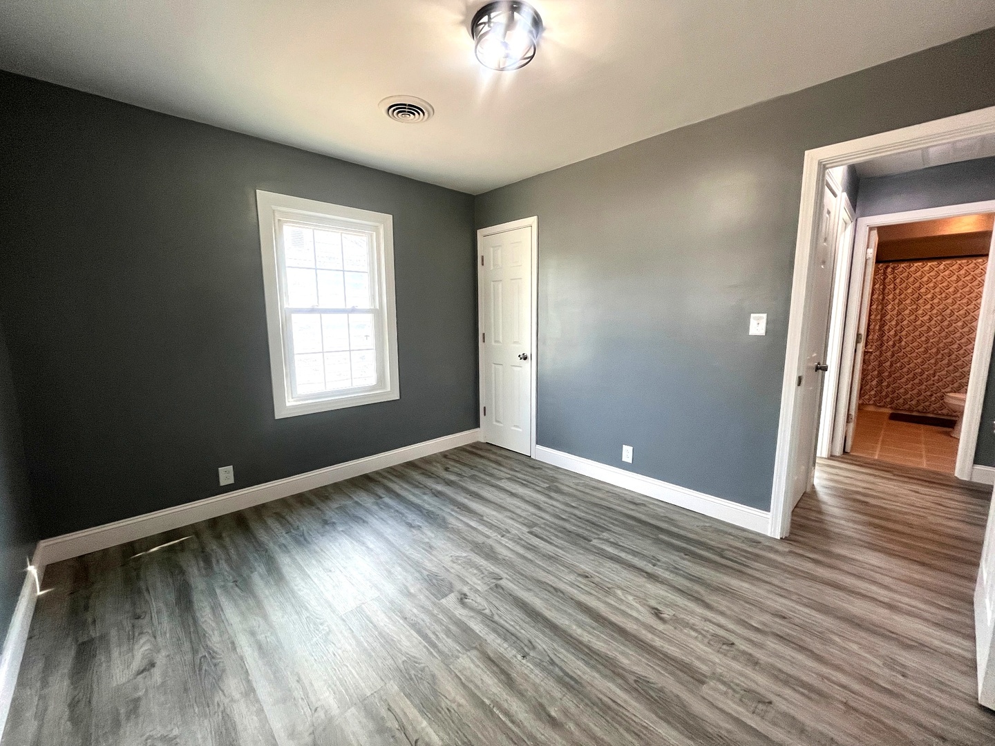 528 West 20th Street Metropolis, IL 62960 - Photo 23 of 26 an empty room with wooden floor and windows