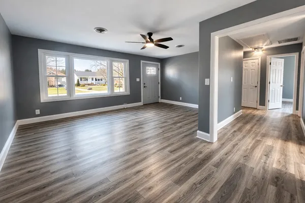 a view of a room with wooden floor and a window