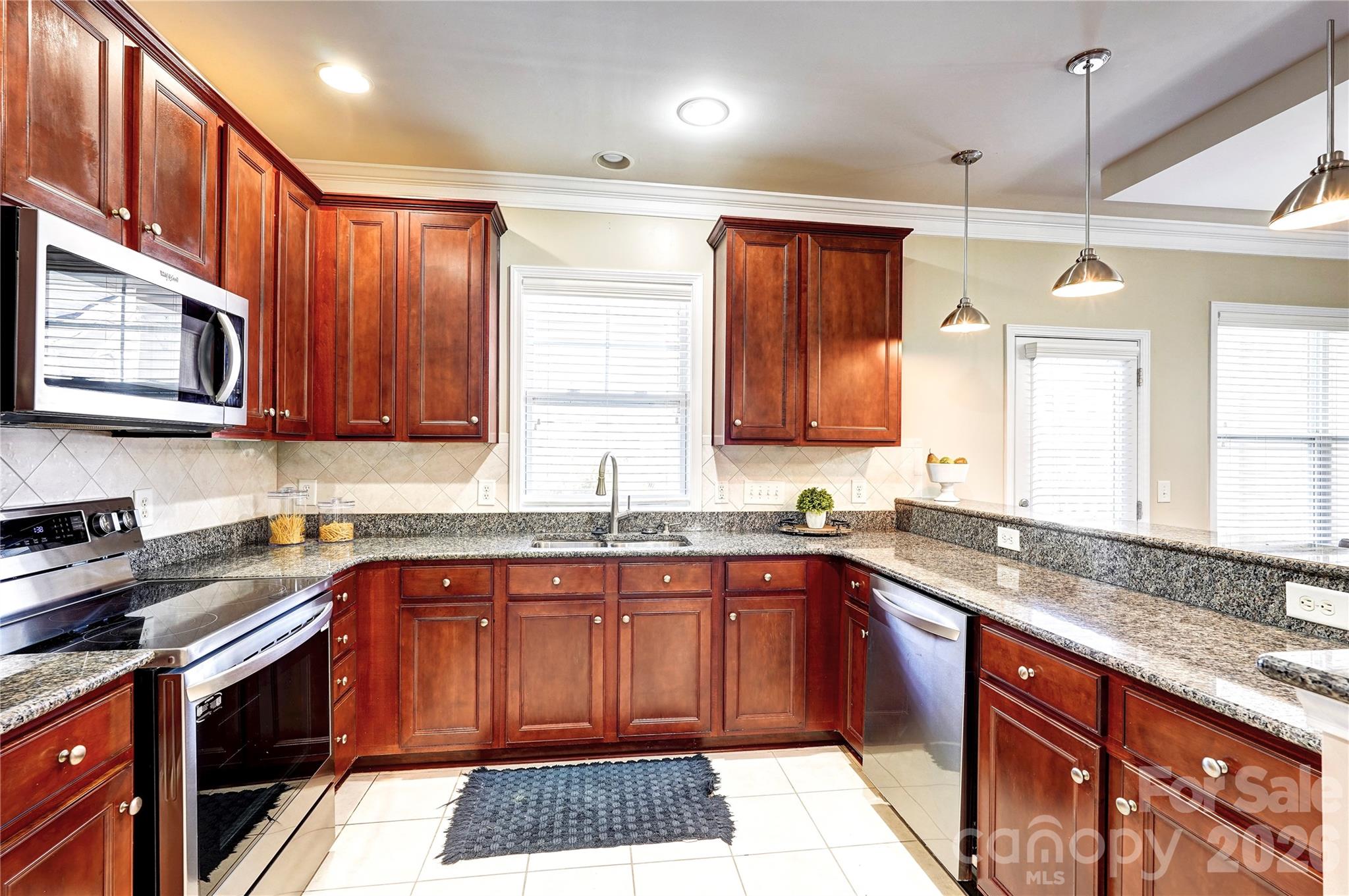 627 Sunfish Lane Tega Cay, SC 29708 - Photo 12 of 42 a kitchen with stainless steel appliances granite countertop a sink stove and cabinets