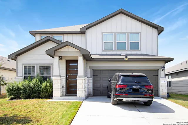 a car parked in front of white house