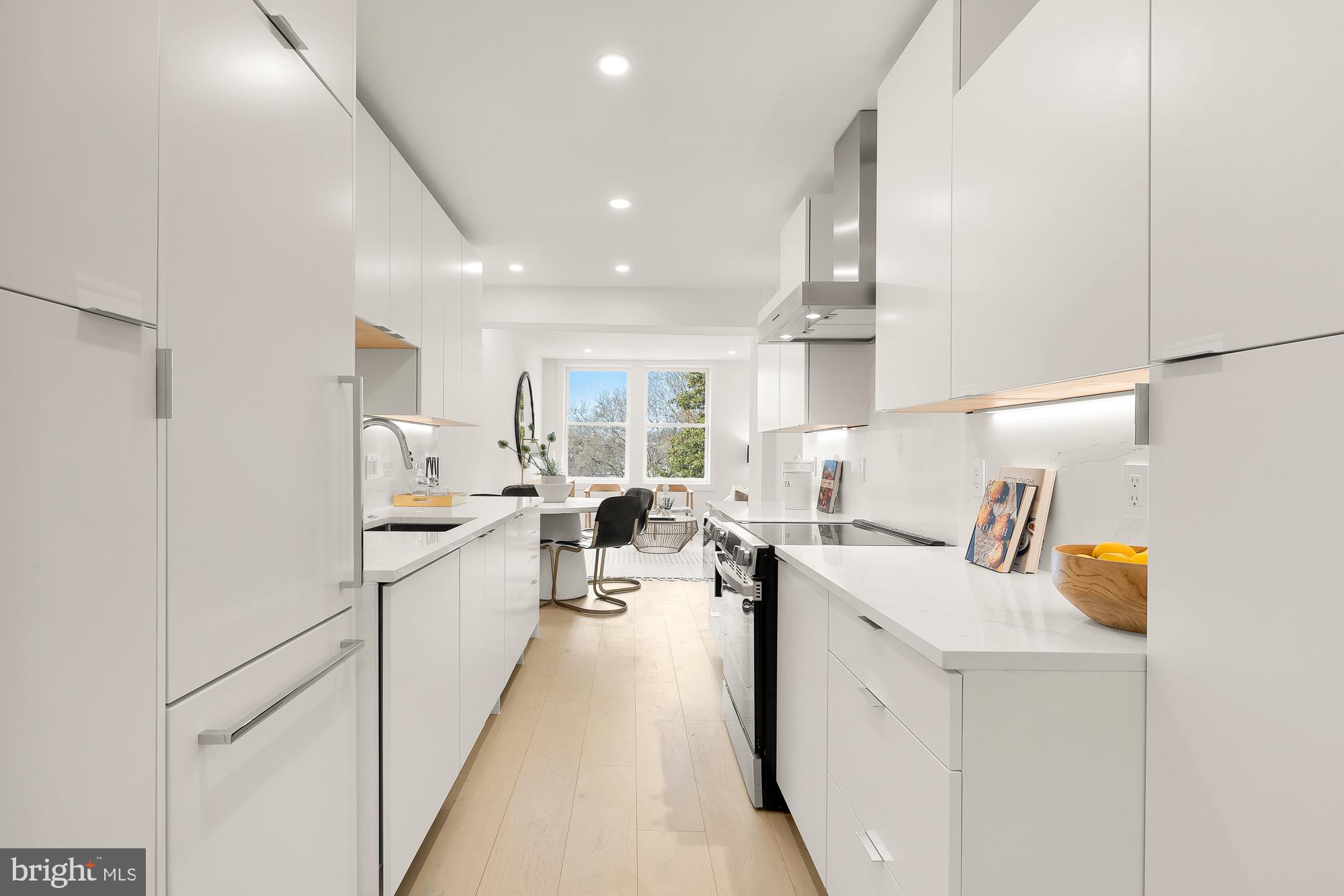 2116 Kalorama Road Northwest, Unit 205 Washington, DC 20008 - Photo 14 of 33 a kitchen with white cabinets and sink