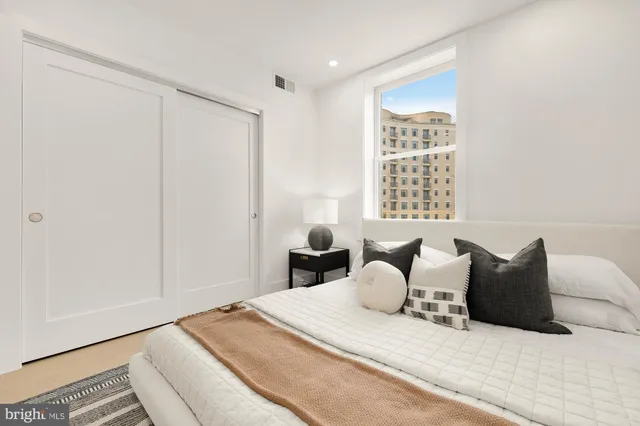 a bedroom with a bed and a window