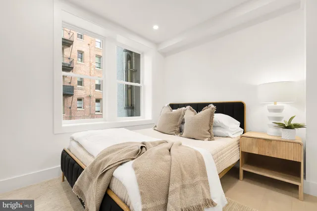 a bedroom with a bed and window